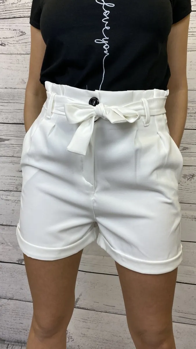 White drawstring shorts with contrasting buttons.